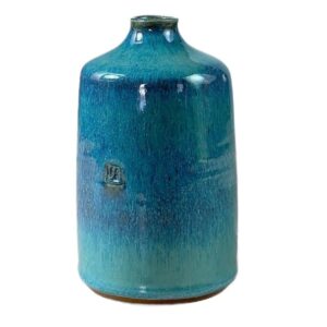 A blue vase with a white background Description automatically generated
