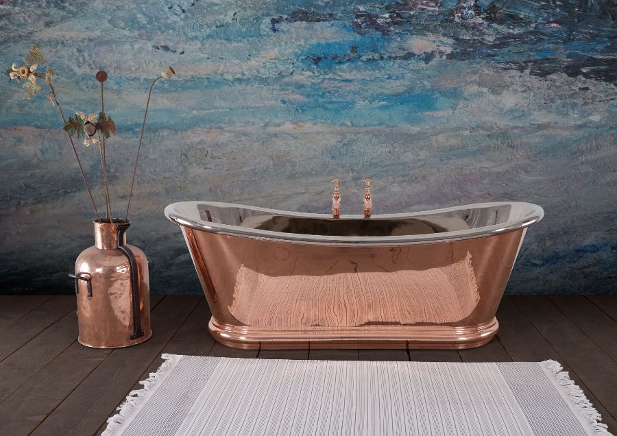 A copper tub next to a vase Description automatically generated