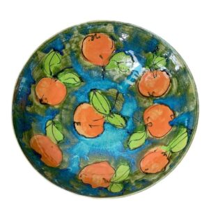 A plate with oranges painted on it Description automatically generated