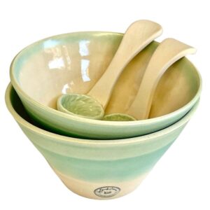 A stack of bowls with spoons Description automatically generated