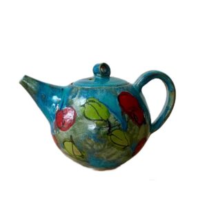 A teapot with a design on it Description automatically generated
