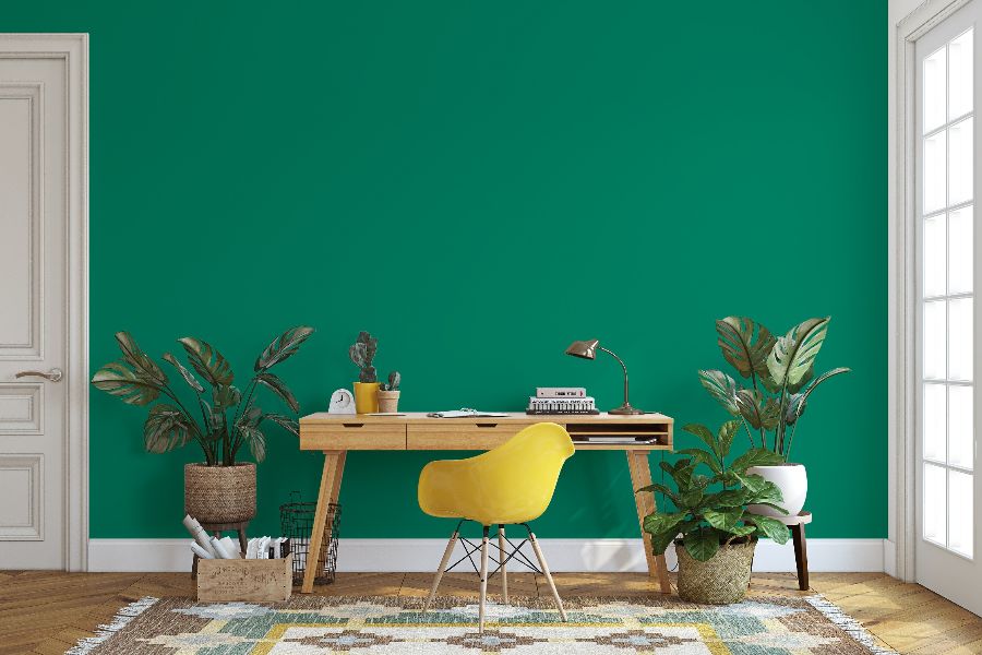 A yellow chair next to a desk Description automatically generated