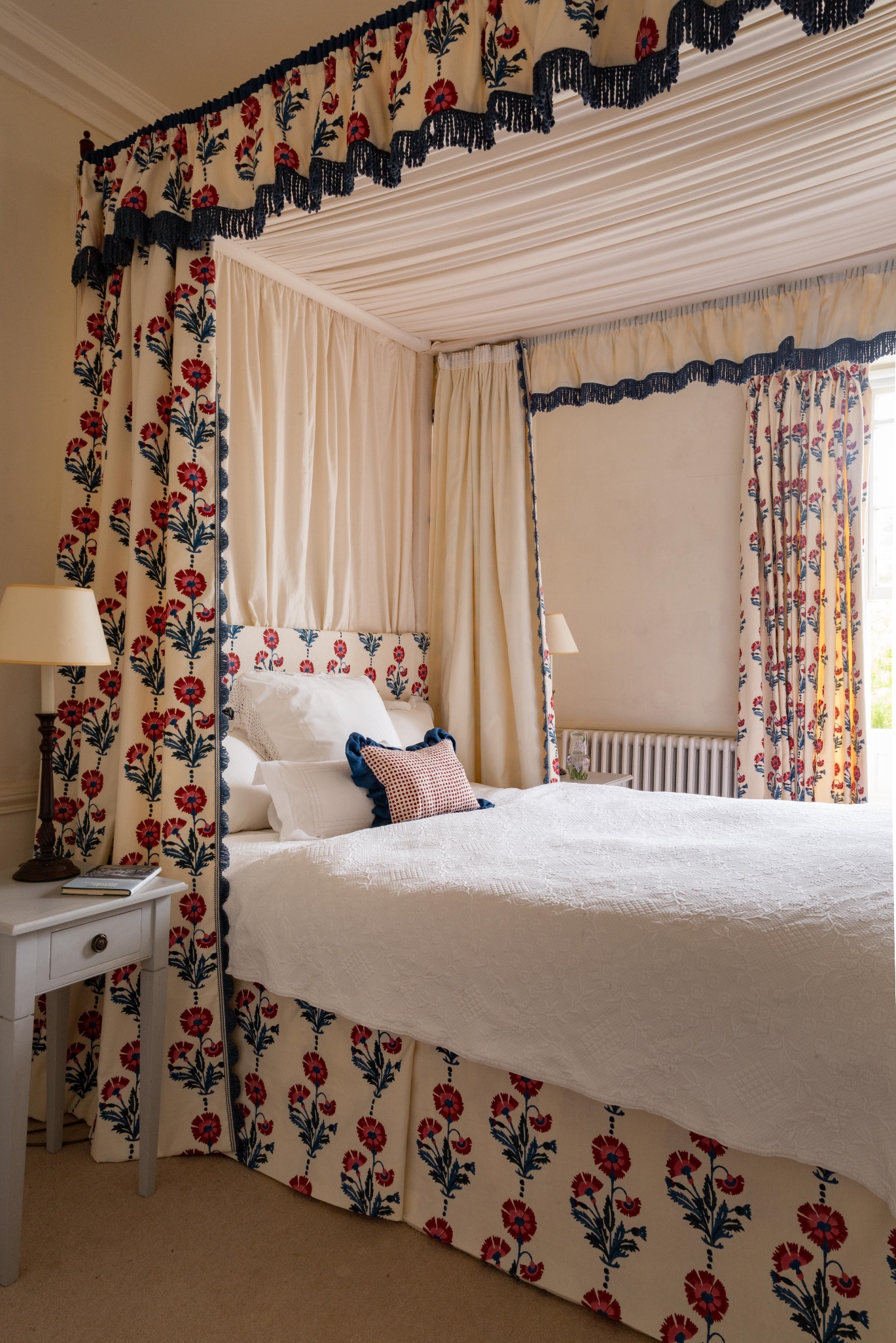 A bed with a four poster bed Description automatically generated