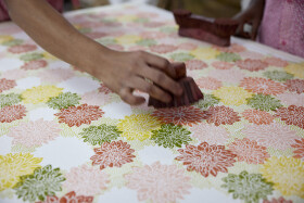 A person cleaning a table Description automatically generated