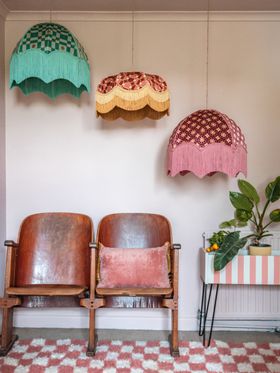 Chairs in a room with chairs and lamps Description automatically generated