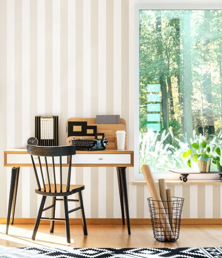 A desk and chair in a room with a window

Description automatically generated