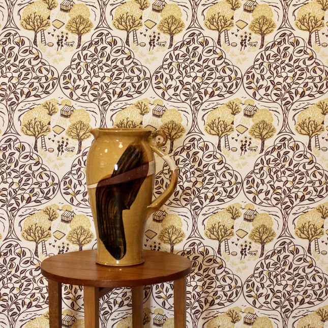 Fiona Howard's Orchard wallpaper in quinceon a wall.