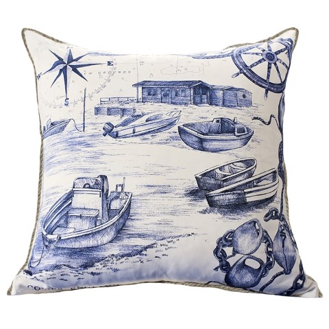 a cushion showing coastal inspired design of boats in a harbour in blue and white