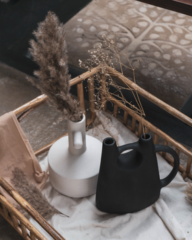 a vase in the shape of a watering can
