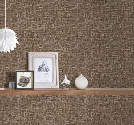 a wallpaper showing a woven effect. A shel;f onbthe wall holds some photographs and ornaments