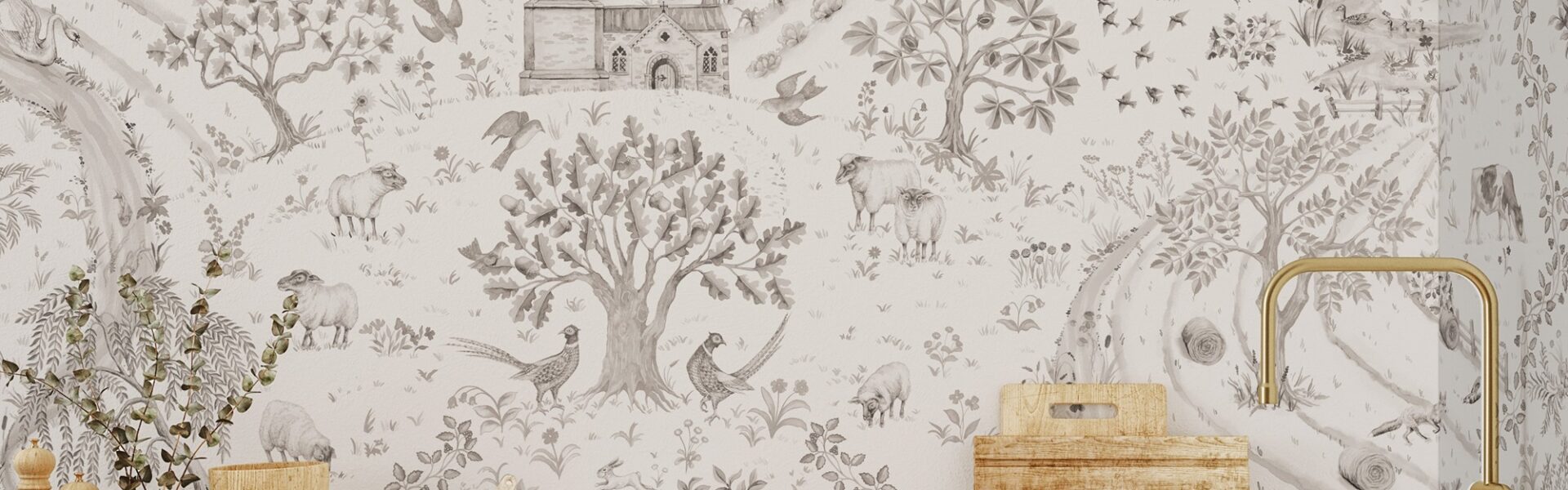 The image features a pastoral wallpaper design that seems to evoke the charm of a countryside daily walk. The sepia-toned illustrations include a variety of elements from rural life such as trees, farm animals like sheep, wild birds, and structures that could be farm fences or parts of a small rural church. The calm and detailed scenery suggests a tranquil harmony with nature. This wallpaper is used as a backdrop for what appears to be a kitchen setting, with wooden utensils and ceramic containers in the foreground, complemented by a brass faucet, enhancing the rustic aesthetic of the space. The overall effect is both nostalgic and inviting, creating a warm atmosphere.