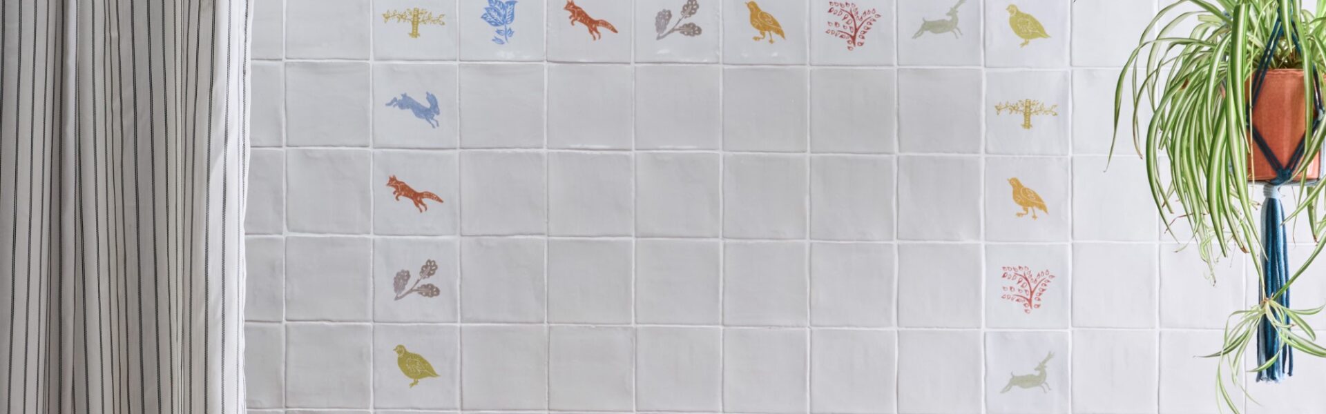 an arrangement of coloured wall tiles featuring images of wildlife