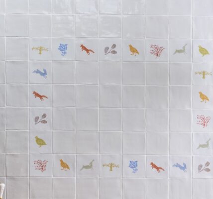 an arrangement of coloured wall tiles featuring images of wildlife