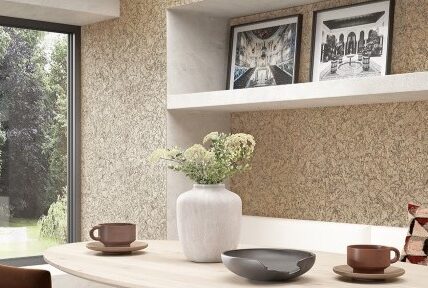 A modern kitchen with cork panelling on the walls.