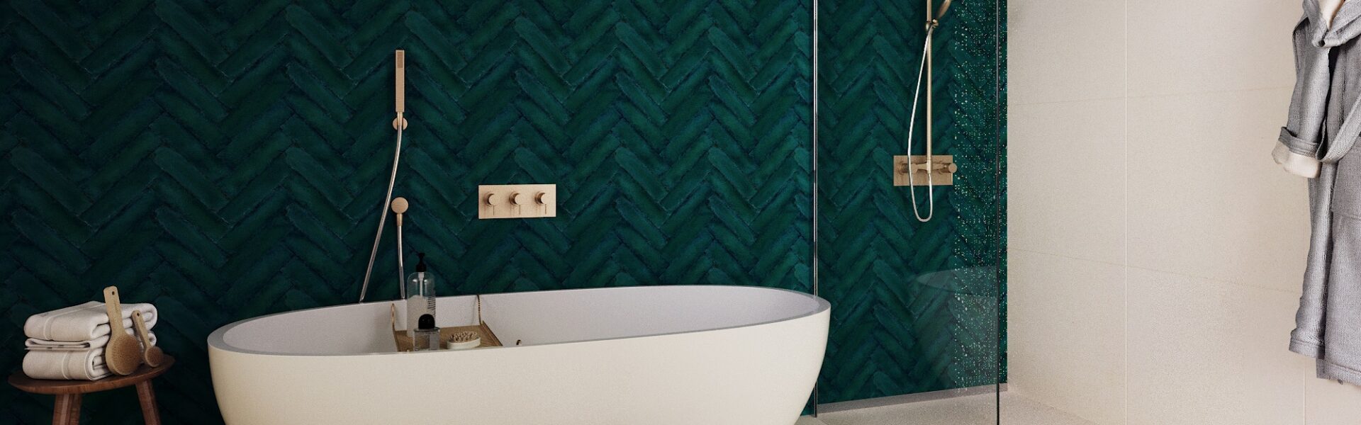 A white bathtub with a chrome taps and showerhead mounted on the wall next to it. The bathtub sits on the floor of a bathroom with bold walls and tile flooring