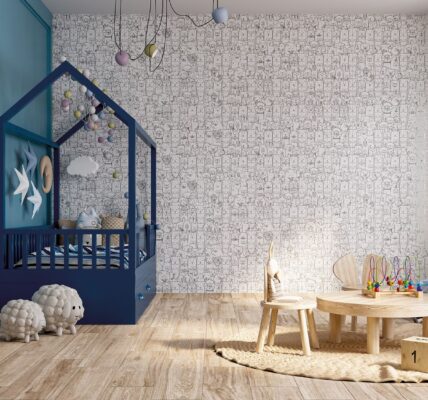 A child's bedroom with a blue canopy bed, a nightstand with a lamp, and a table with two chairs. The wall is tiled with a black and white dog-inspired tile.