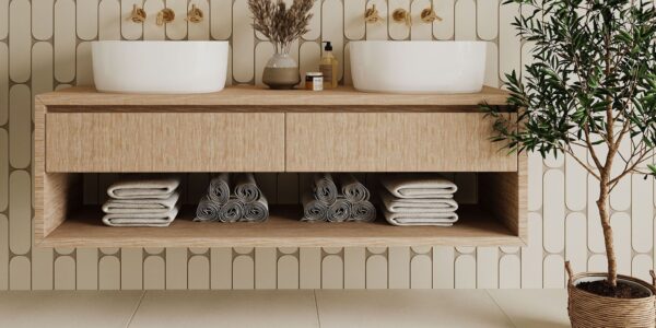 A bright bathroom with a double vanity unit, two sinks, and a houseplant for decoration.