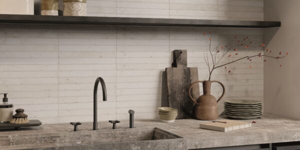 The image shows a kitchen countertop made of porcelain tile. The tile white. The worktop is installed in a subway tile pattern, with the tiles running horizontally.