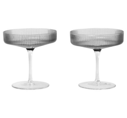 Two smoked grey champagne glasses on a white background.