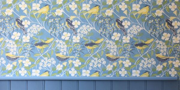 A blue wallpaper with a subtle, organic pattern reminiscent of birdsong waves.