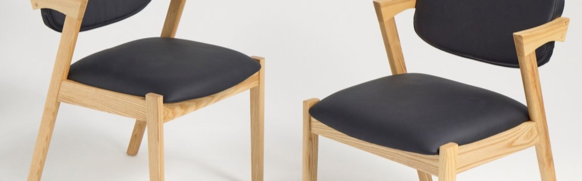 Two modern dining chairs with a clean and minimalist design