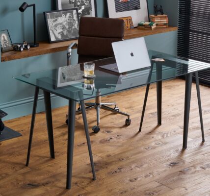 The image shows a modern home office space with dark wood floors and a glass desk.