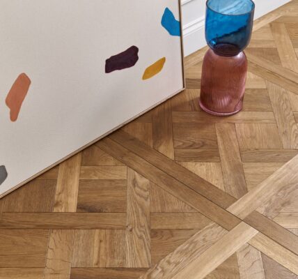 Beautiful wood panelling in an ornate pattern. The wood appears to be a light oak colour with a natural finish.
