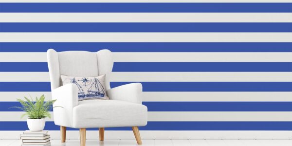 A living room wall with bold blue and white striped wallpaper