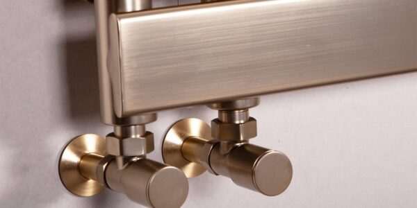 Luxurious brushed brass heated towel rail with stylish round valves