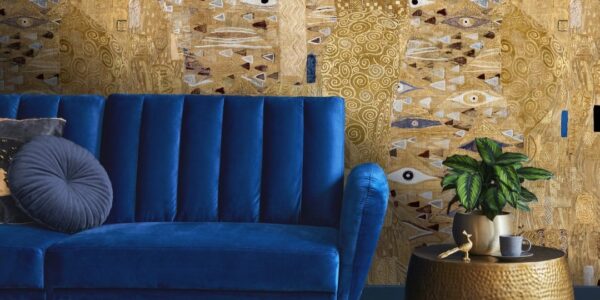 The wallpaper features a large-scale abstract design with golds, browns, and blues. There are hints of faces and eyes within the pattern, giving it a surreal and intriguing quality.