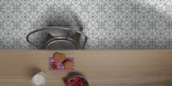 The floor is covered in a white and grey patterned tile. The pattern consists of repeating four-leaf clover shapes with a circular design in the centre. The pattern creates a sense of symmetry and elegance.