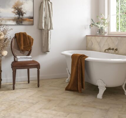 Create a serene oasis with our freestanding bathtub, complete with a vintage-inspired chair, plush towels, and a decorative arrangement. The herringbone tile backsplash adds a touch of elegance, while the neutral colour palette creates a calming atmosphere
