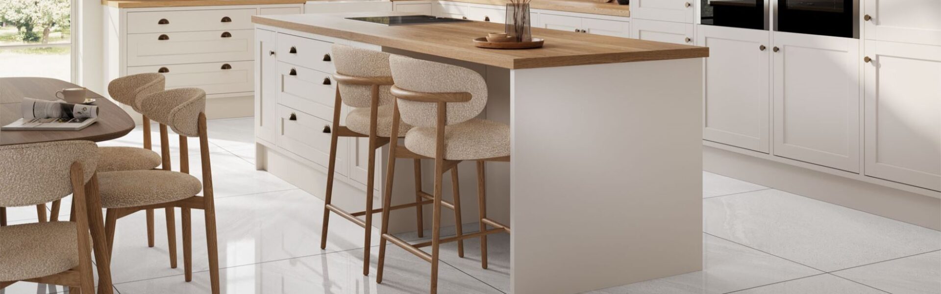 A spacious and stylish kitchen with a large island and a dining area. The kitchen has a modern design with white cabinets, a wooden countertop, and a white tile floor.