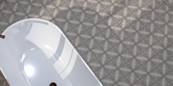 Detailed view of grey and white patterned floor tiles in a bathroom, with a portion of a white bathtub visible.