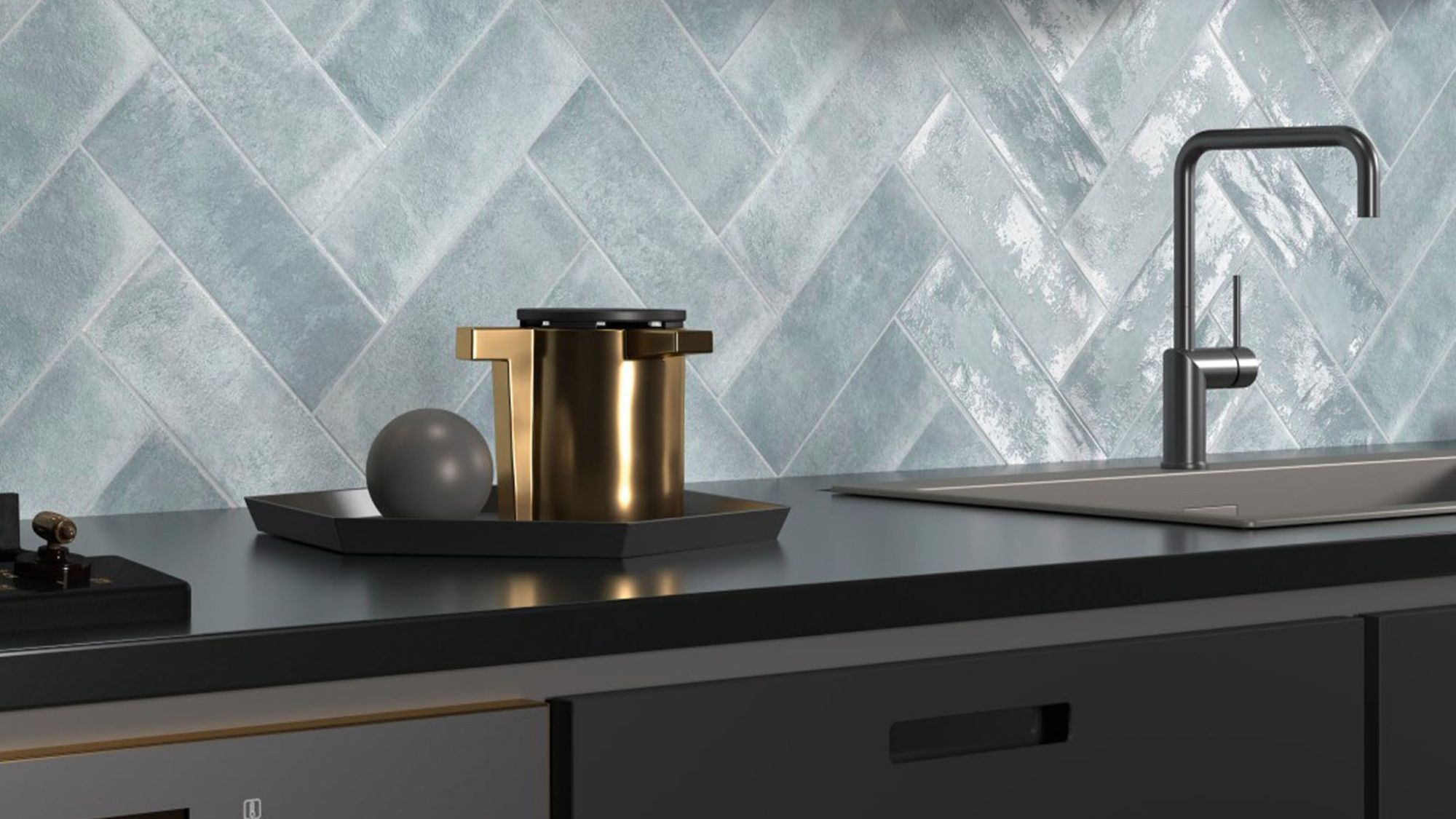 The backsplash features light blue or grey tiles arranged in a herringbone pattern. The tiles have a distinctive textured, almost wavy or rippled surface, giving them a handmade or artisanal appearance.