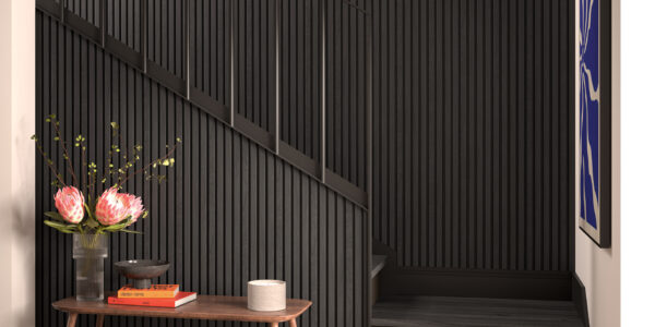 A modern interior space featuring a dark, slatted wall treatment that extends up a staircase.