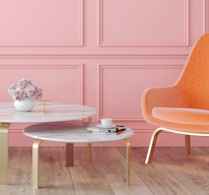A pink panelled wall adds a touch of elegance, and the light wood flooring keeps everything feeling airy.