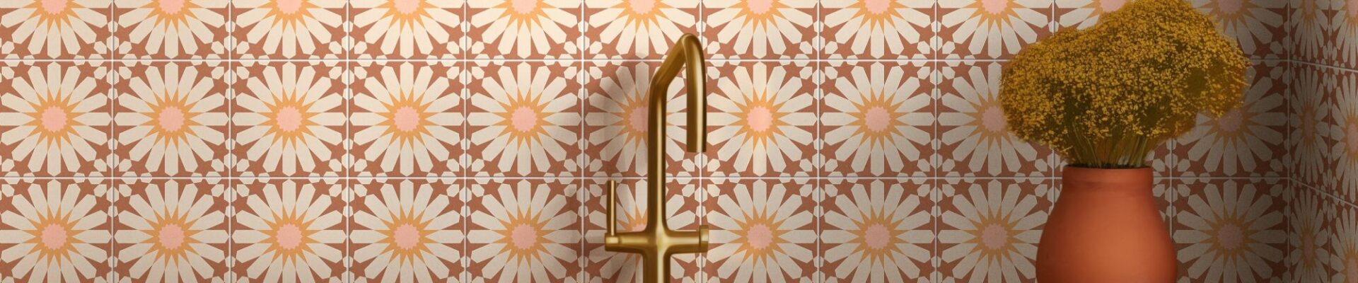 The backsplash is covered in ceramic tiles with a repeating floral pattern. The tiles are a warm terracotta colour with a large, stylized daisy design in the centre of each one. The daisy petals are a light cream or off-white, and the centres are a soft pink.