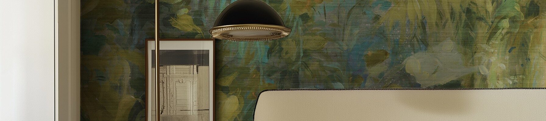 A bedroom with a textured green and gold abstract botanical wallpaper mural, featuring a bed with a beige headboard and a black-and-brass floor lamp.