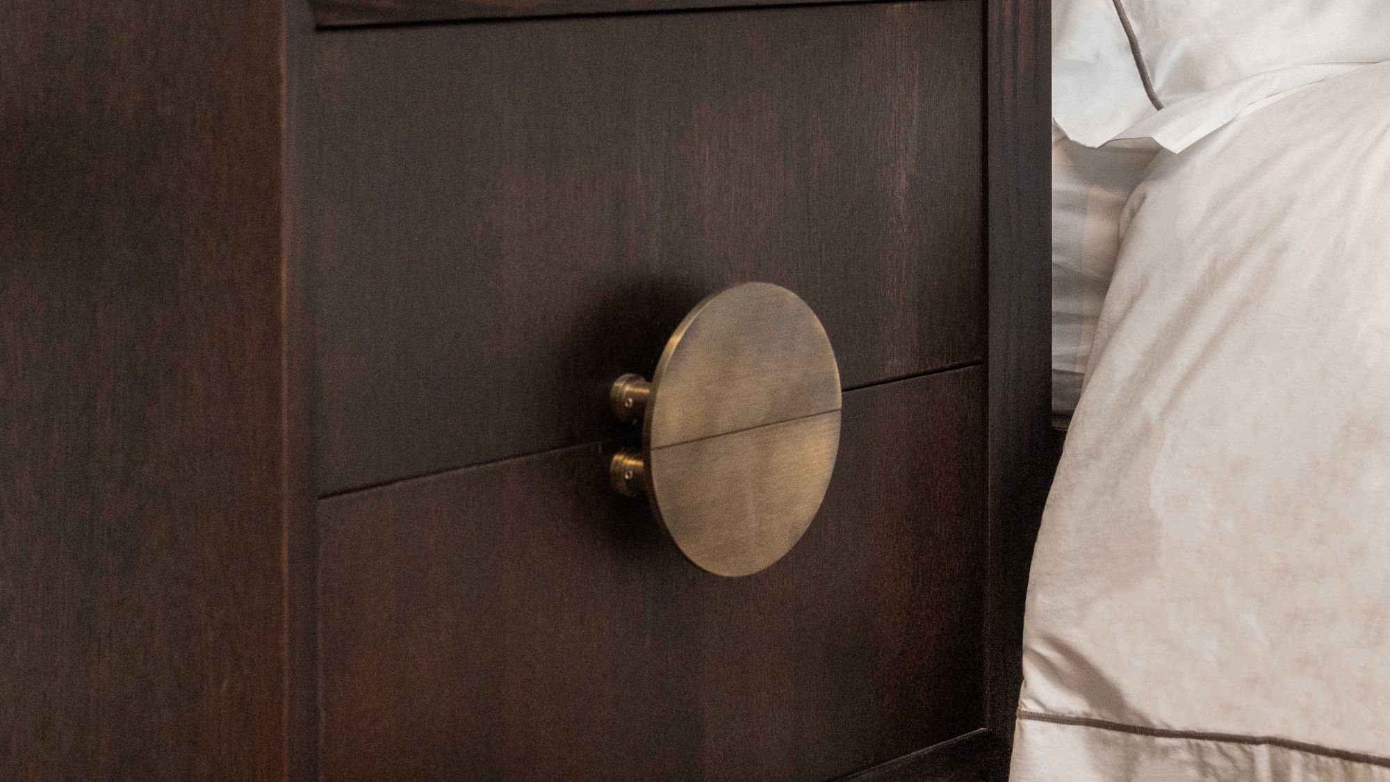 A Solid Brass Half Moon Handle in an Antique Gold or Brushed Brass finish. These handles are typically sold as a pair, allowing them to be mounted back-to-back to form a full circle, as seen in your image on the two drawers of the dark wooden cabinet.