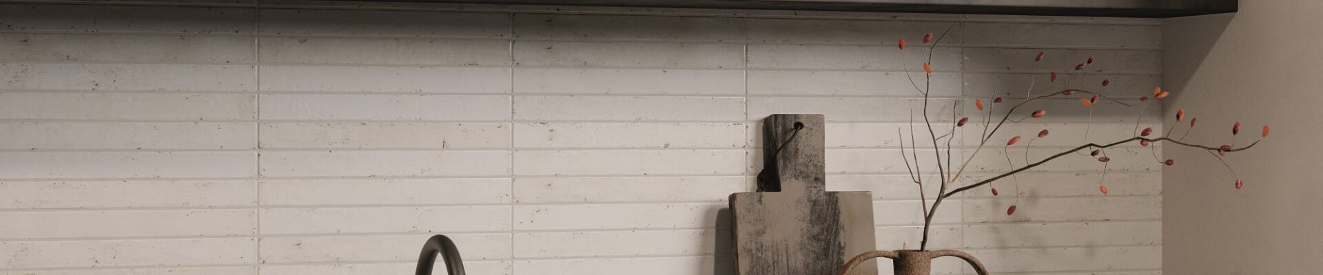 A kitchen splashback with light-coloured, rectangular tiles laid in a horizontal pattern, likely a subway or brick-style layout. The tiles appear to have a handmade or distressed texture with slight variations in colour and surface, giving them an artisan feel. They look like a creamy white or very pale beige/grey.