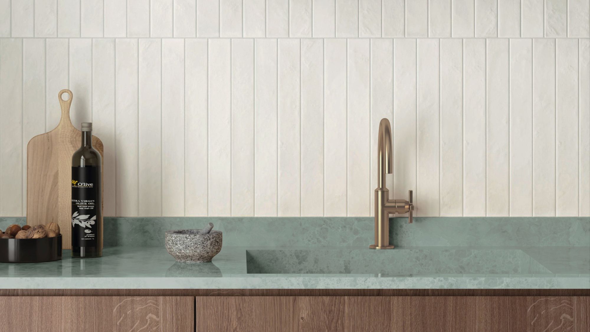 An eye-level, horizontal shot of a modern, minimalist kitchen features a vertical stack-bond backsplash made of textured, off-white rectangular tiles.