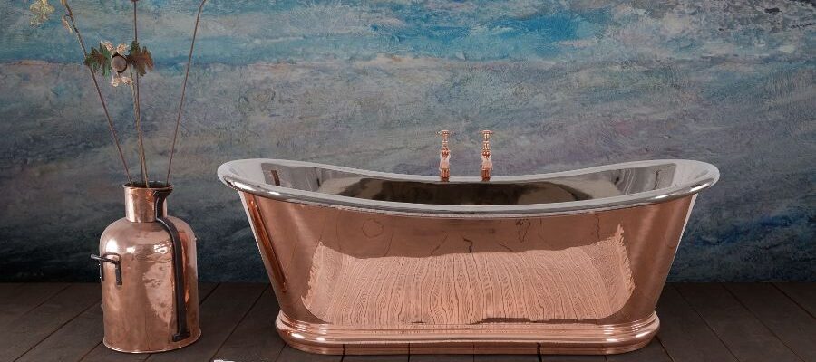 A copper tub next to a vase Description automatically generated
