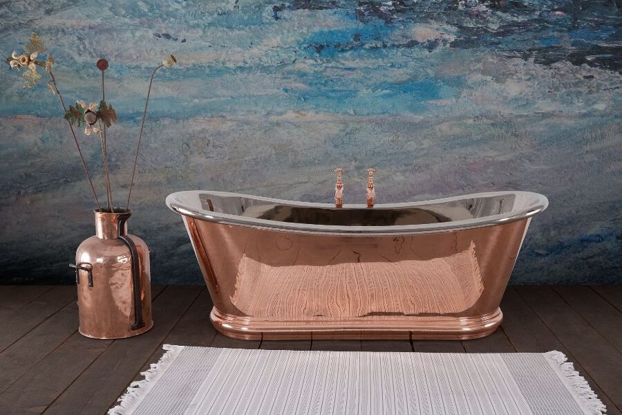A copper tub next to a vase Description automatically generated