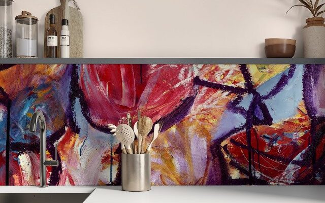 a glass kitchen splashback in bright colours from Red Dog Glass Design. In situ in a kitchen