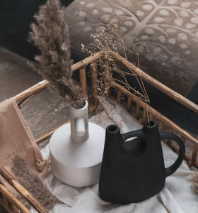 a vase in the shape of a watering can