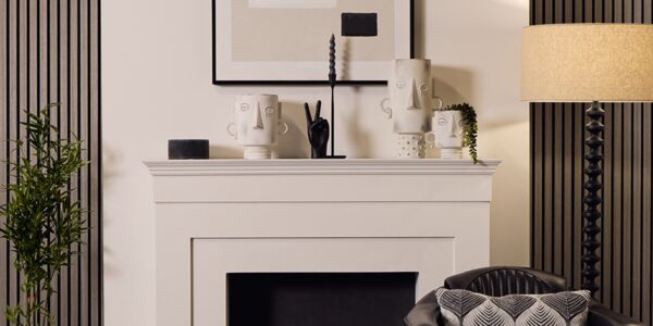 A decorative vase with a blue stone effect and black details. The design is simple and modern, with a series of black droplet-like patterns arranged in rows around the body of the vase. The neck of the vase is narrow and cylindrical, contrasting with the wider base, giving it an elegant profile that could complement a contemporary interior design.