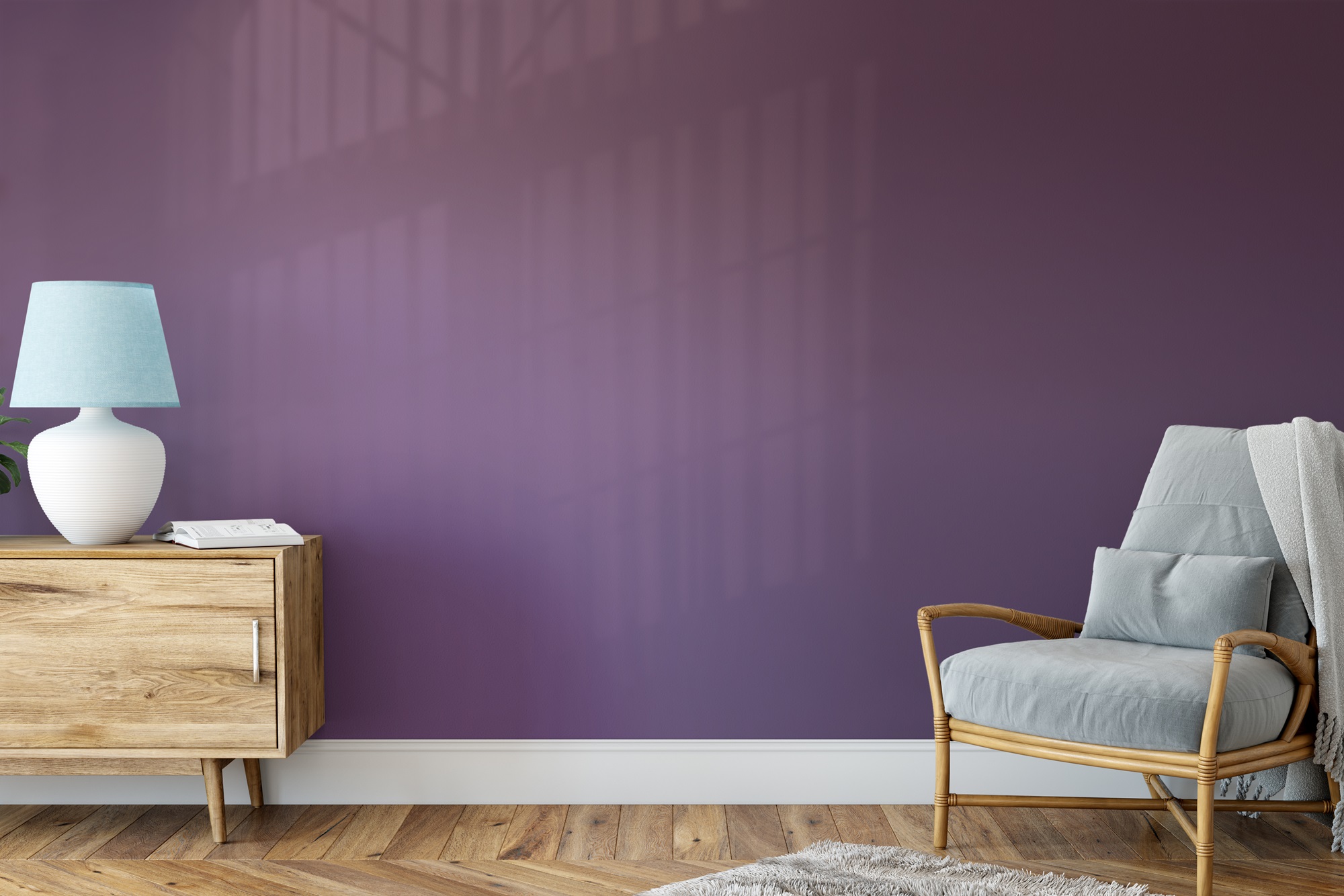 A living room with a bold purple accent wall and a comfy armchair with a lamp next to it.