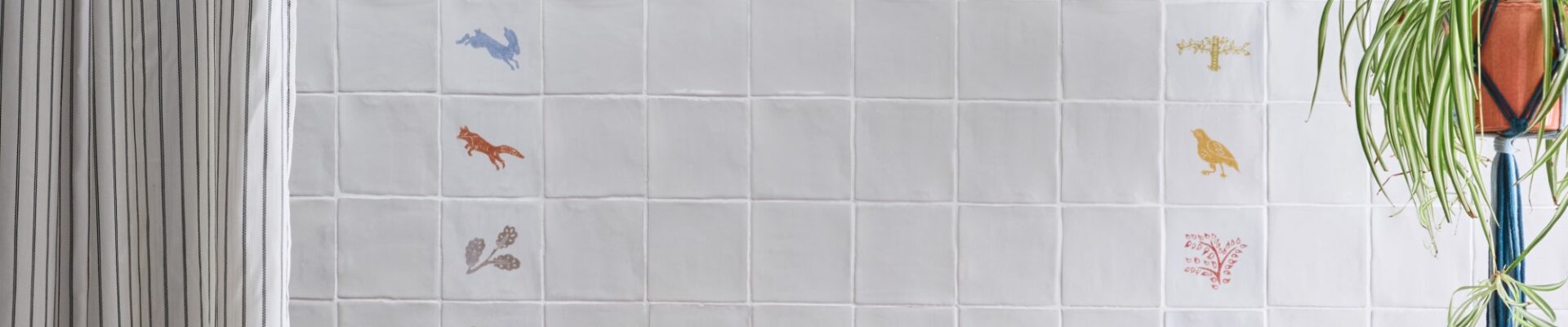 an arrangement of coloured wall tiles featuring images of wildlife