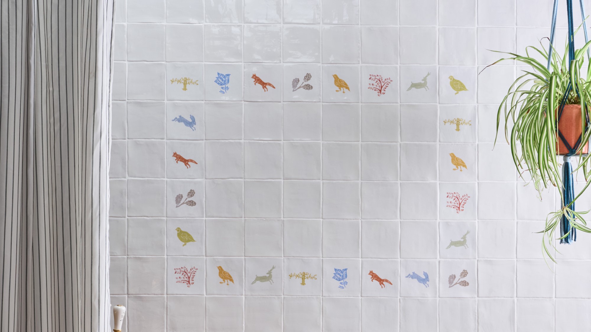 an arrangement of coloured wall tiles featuring images of wildlife